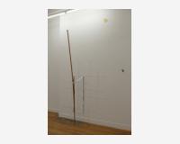 "Le porteur du bleu plus haut" - "the one who raises the blue higher", 2025 a cutout drawing pinned to the wall and a wooden stick whose end has been dipped in blue acrylic paint - (the drawing: Indian ink, graphite pencil on Tyvek, 18 pins - 180 x 150 cm)