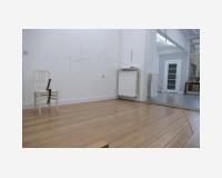 "Le poids de la peinture" - "The weight of paint", 2025 - a wooden stick whose end has been dipped in blue acrylic paint